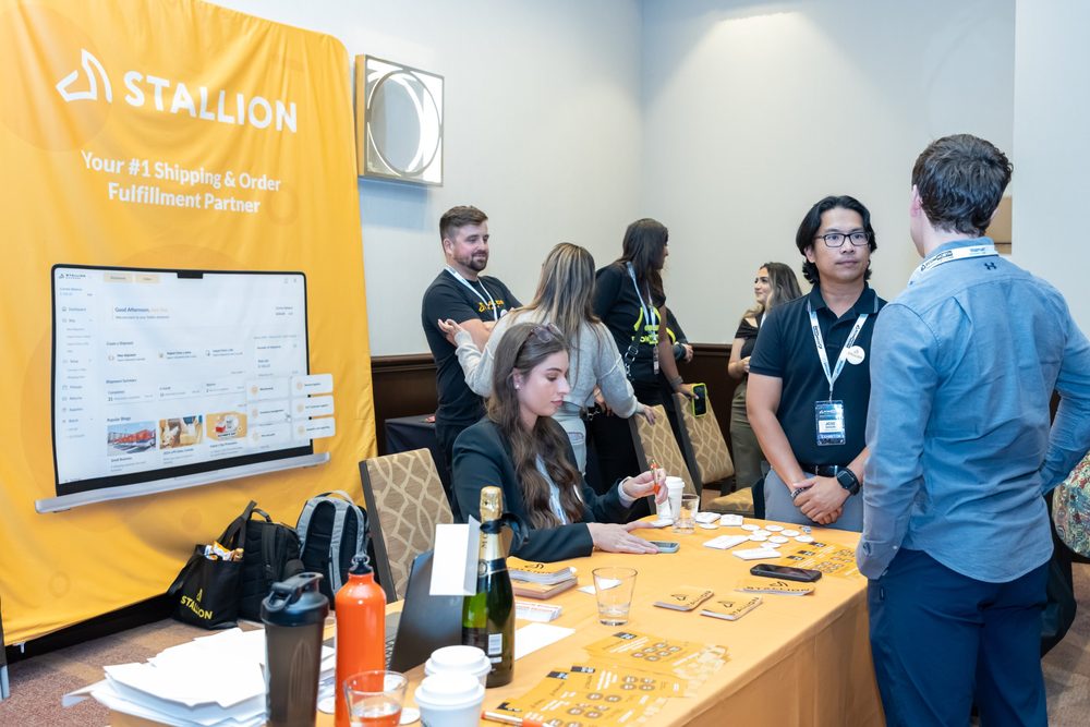 Attendees in conversation at the Stallion Express booth