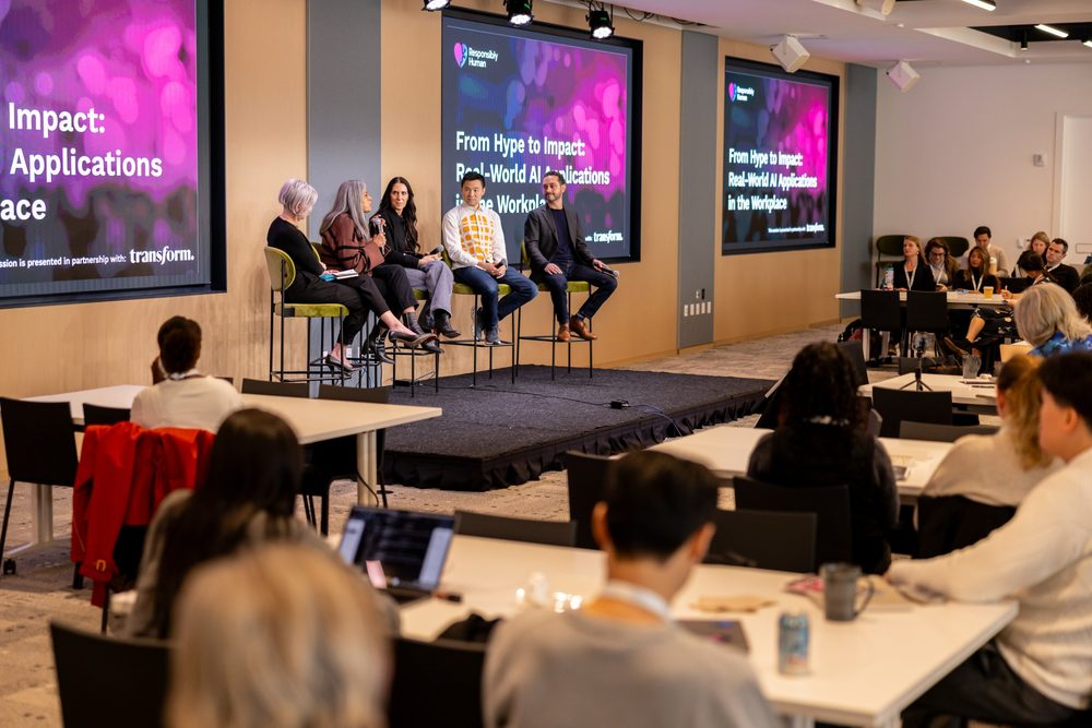 A panel discussion in front of Responsibly Human screens